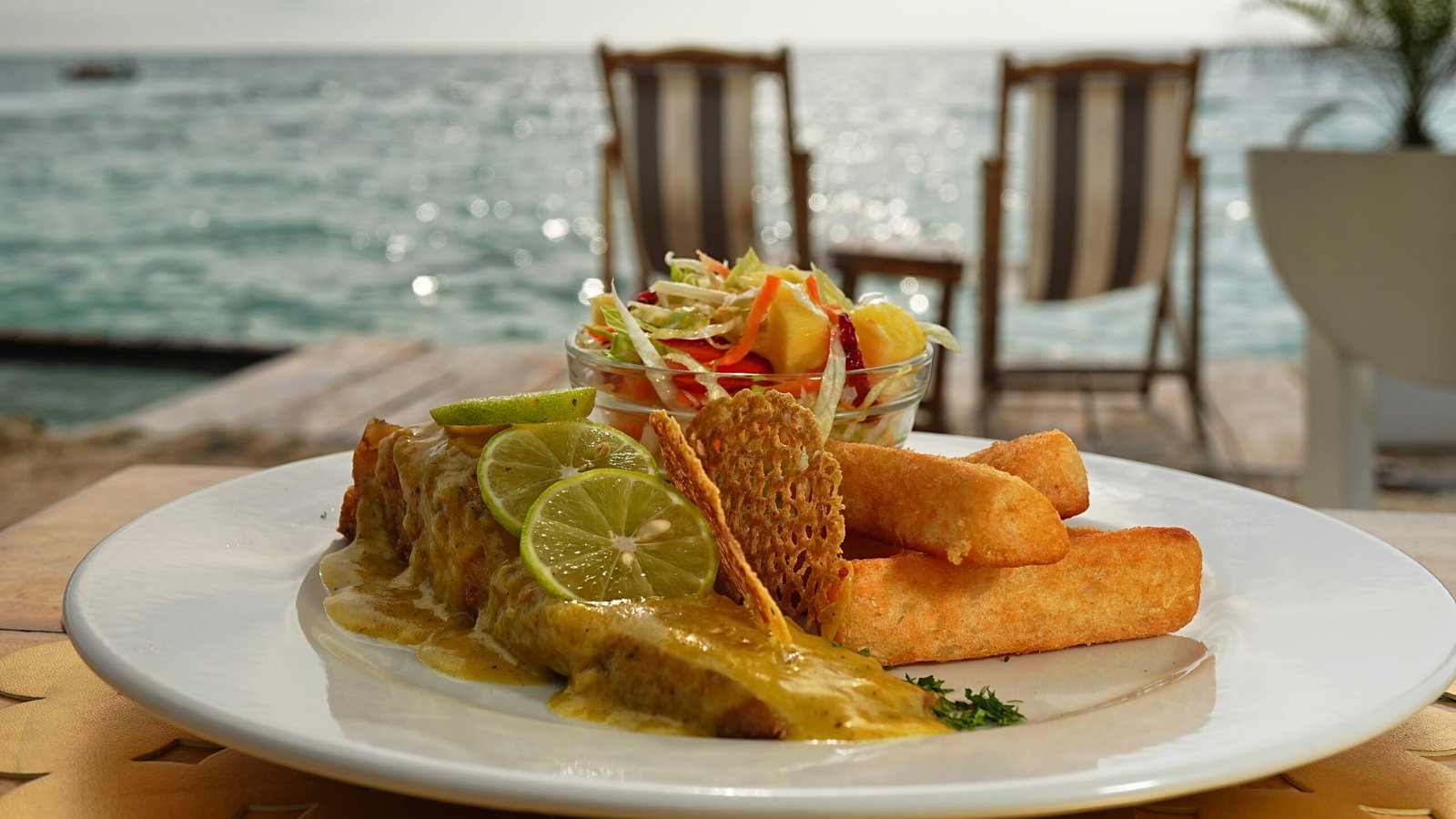 Plato de pescado frito con tostones y ensalada, gastronomía caribeña